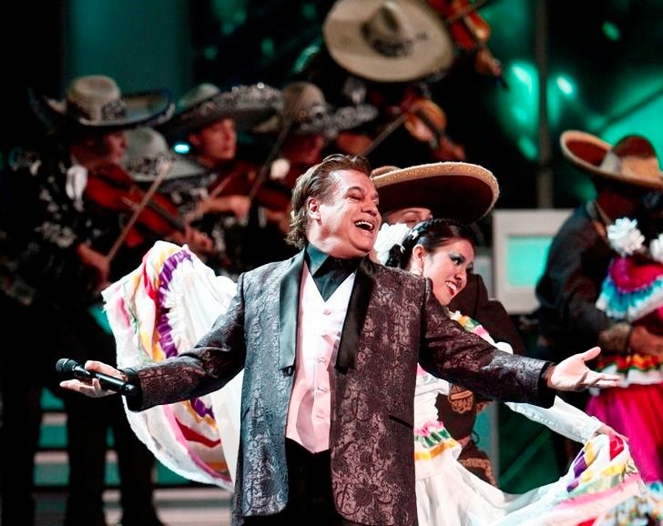 A photo from the Latin GRAMMYs program with MFDC dancing alongside the world-famous singer Juan Gabriel